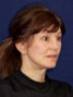 a woman with brown hair and a ponytail